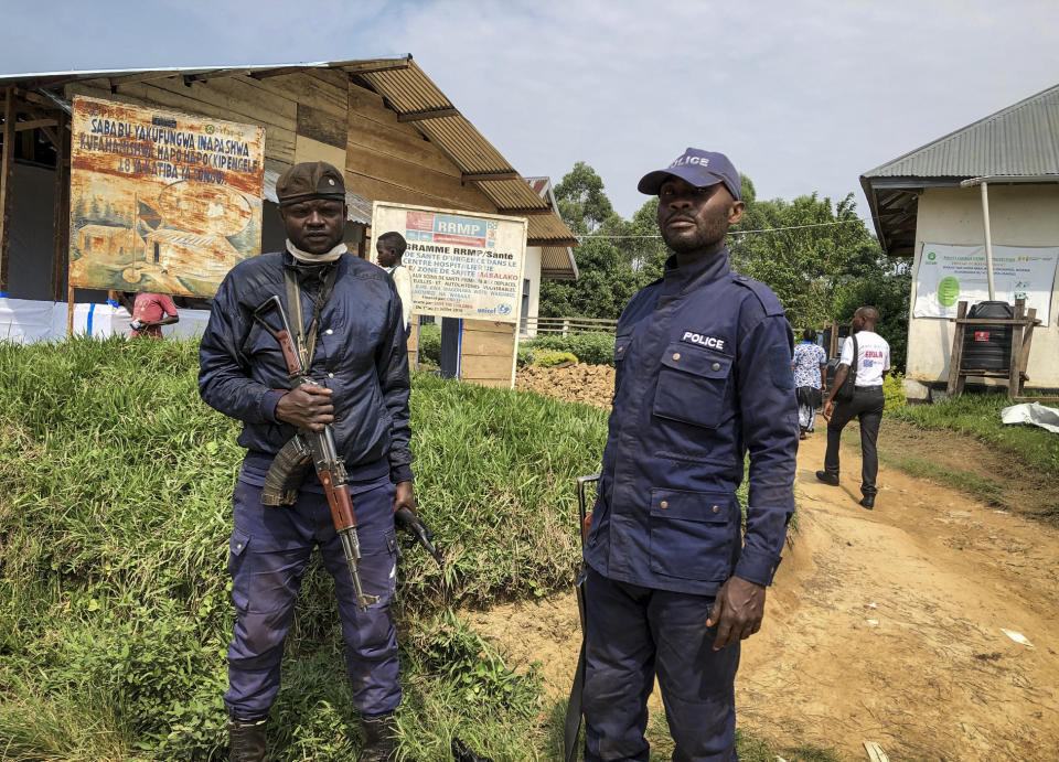 Congolese police guard a health center while Ebola vaccinations take place, in the village of Mabalako, in eastern Congo Monday, June 17, 2019. Health officials in eastern Congo have begun offering vaccinations to all residents in the hotspot of Mabalako whereas previous efforts had only targeted known contacts or those considered to be at high risk. (AP Photo/Al-hadji Kudra Maliro)