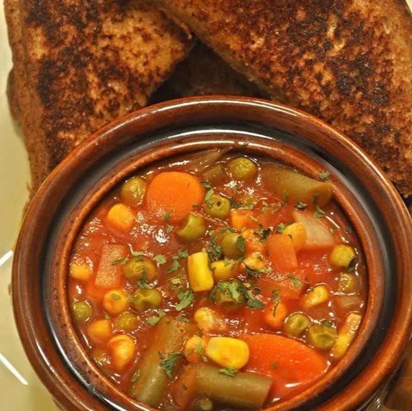 <p>Krista Marshall</p><p>You can't go wrong with a bowl of tomato soup loaded with veggies. You can go wrong, though, if you don't serve it with hot grilled cheese on the side. </p><p><strong>Get the recipe: <a href="https://parade.com/841905/kristamarshall/slow-cooker-tomato-vegetable-soup/" rel="nofollow noopener" target="_blank" data-ylk="slk:Slow Cooker Tomato Vegetable Soup;elm:context_link;itc:0;sec:content-canvas" class="link ">Slow Cooker Tomato Vegetable Soup</a></strong></p>