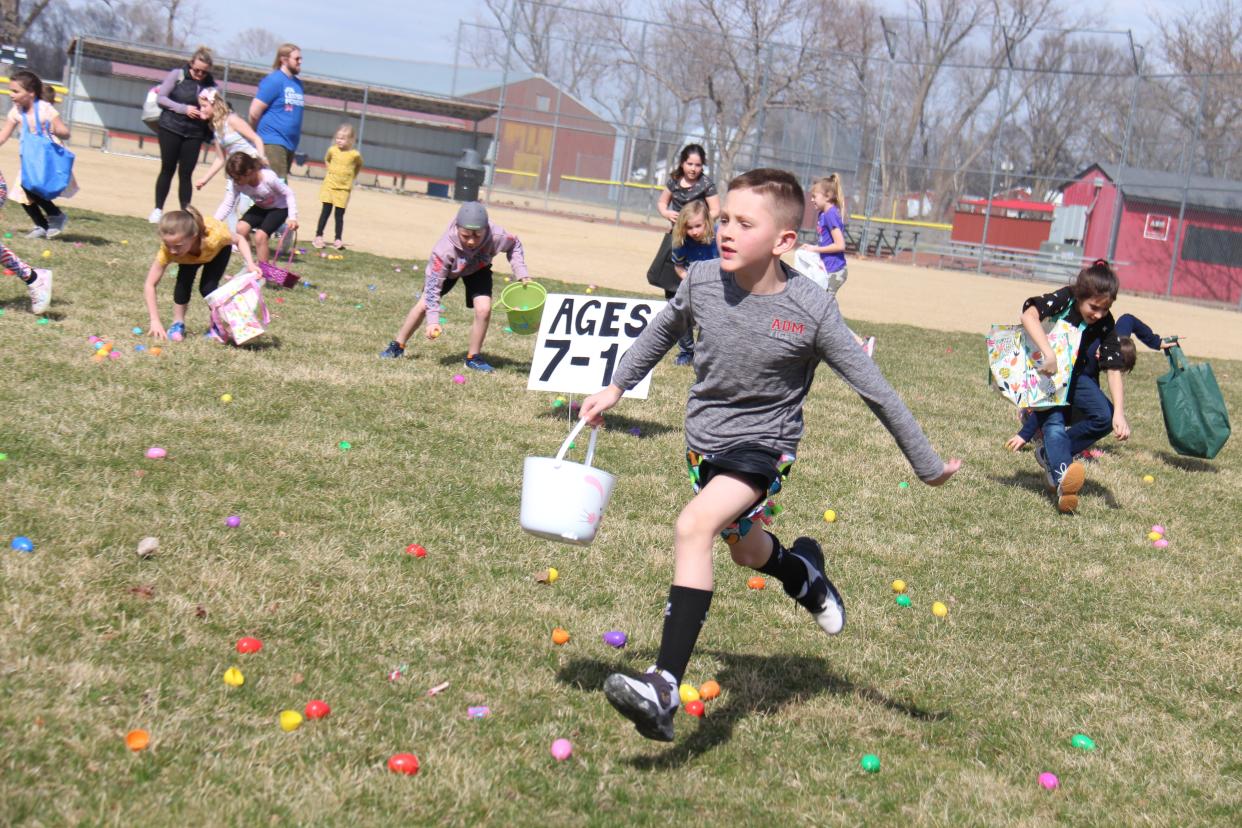 Kids race to pick up eggs during the Adel Kiwanis Easter Egg Hunt on Sunday, April 10, 2022, at Kinnick-Feller Riverside Park in Adel.