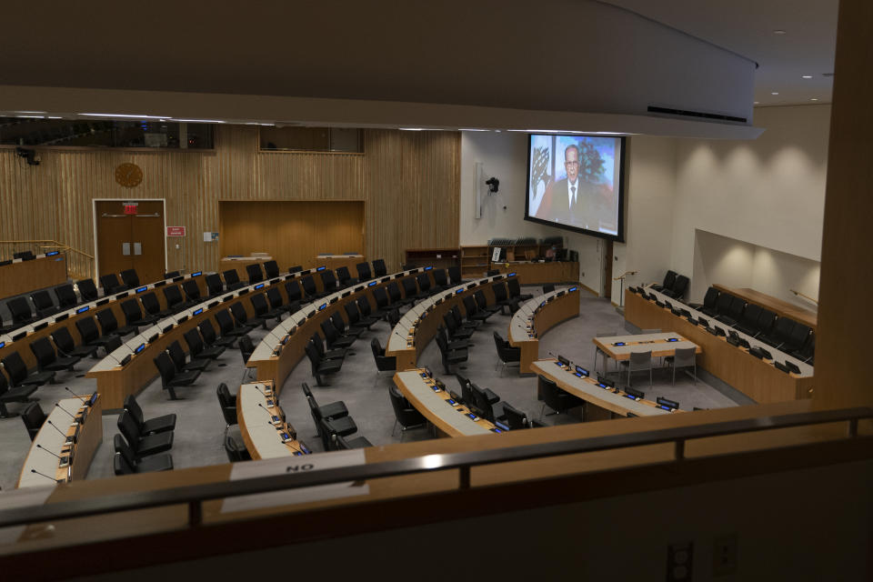 Lebanese President Michel Naim Aoun is seen on a video screen in an empty conference room remotely addressing the 75th session of the United Nations General Assembly, Wednesday, Sept. 23, 2020, at U.N. headquarters. This year's annual gathering of world leaders at U.N. headquarters will be almost entirely "virtual." Leaders have been asked to pre-record their speeches, which will be shown in the General Assembly chamber, where each of the 193 U.N. member nations are allowed to have one diplomat present. (AP Photo/Mary Altaffer)