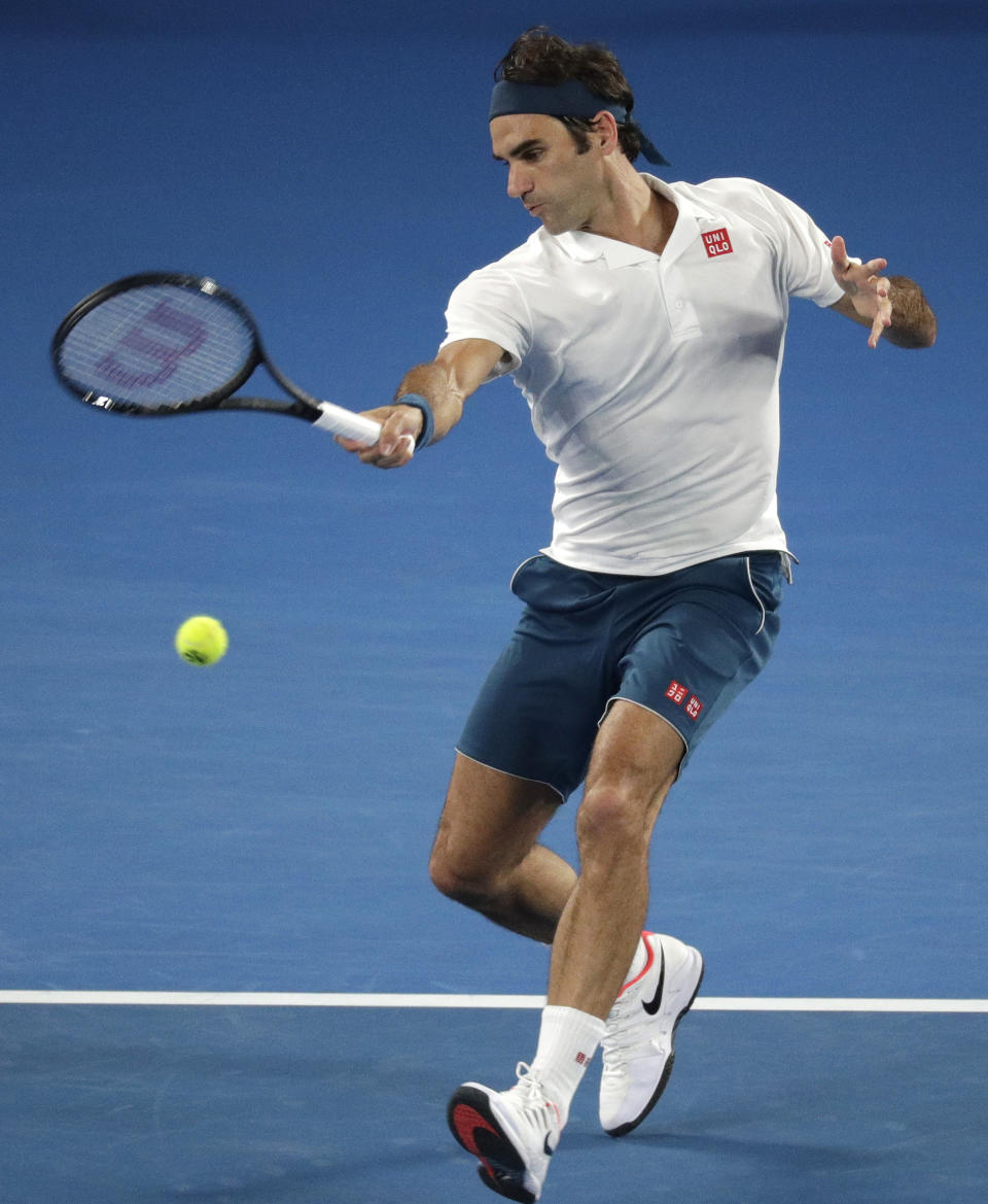 Switzerland's Roger Federer makes a forehand return to United States' Taylor Fritz during their third round match at the Australian Open tennis championships in Melbourne, Australia, Friday, Jan. 18, 2019. (AP Photo/Kin Cheung)