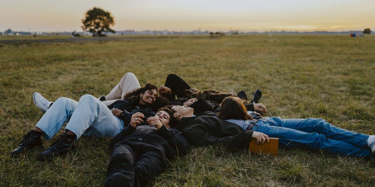 a group of people lying on the grass