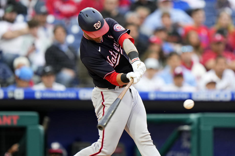 Washington Nationals' Yan Gomes hits an RBI-single off Philadelphia Phillies pitcher Zack Wheeler during the first inning of a baseball game, Tuesday, June 22, 2021, in Philadelphia. (AP Photo/Matt Slocum)