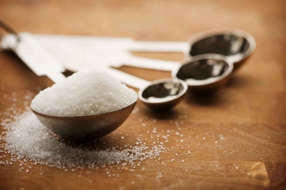 white sugar in measuring spoons