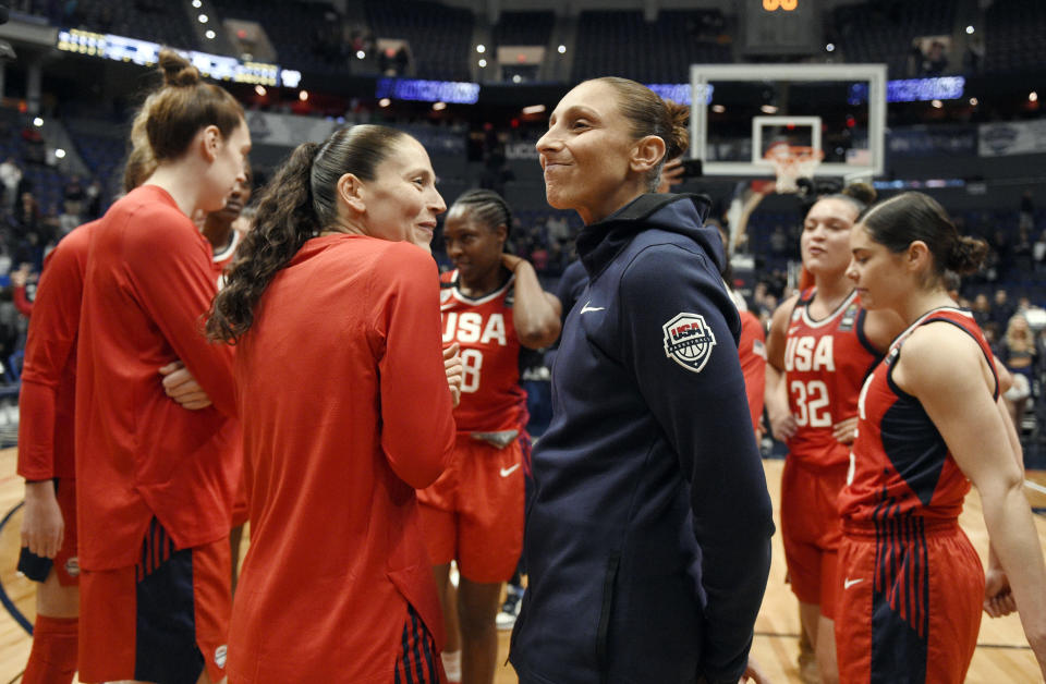 FILE - In this Jan. 27, 2020, file photo, United States' Sue Bird, left, and Diana Taurasi share a light moment at the end of an exhibition basketball game against Connecticut in Hartford, Conn. Taurasi and Bird know that they are on the tail end of their incredible basketball careers. After both stars missed last season due to injuries, skipping the 2020 season could have meant the end of their illustrious careers because it would have been difficult to return after two years off according to them. (AP Photo/Jessica Hill, File)