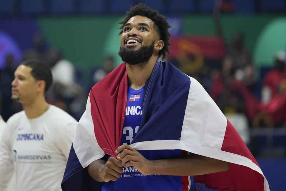 Dominican Republic forward Karl-Anthony Towns (32) celebrates after winning against Angola during their Basketball World Cup group A match at the Araneta Coliseum, Manila, Philippines on Tuesday, Aug. 29, 2023. (AP Photo/Aaron Favila)