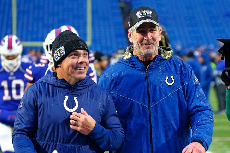 Indianapolis Colts head coach Frank Reich, right, and special teams coordinator Bubba Ventrone walk off the field after a 41-15 win over the Buffalo Bills in an NFL football game in Orchard Park, N.Y., Sunday, Nov. 21, 2021. (AP Photo/Jeffrey T. Barnes)