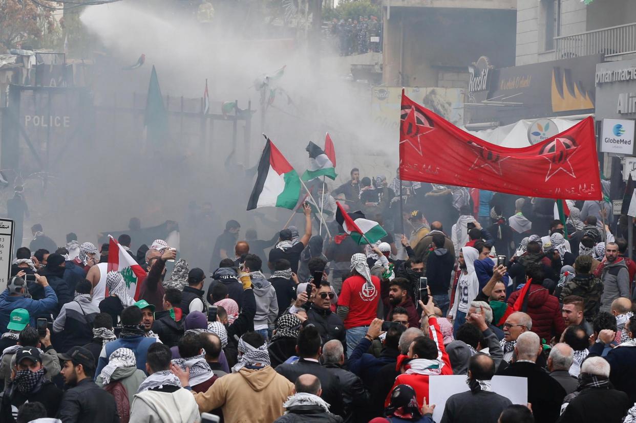 Protesters are sprayed with water near the US Embassy in Lebanon: REUTERS