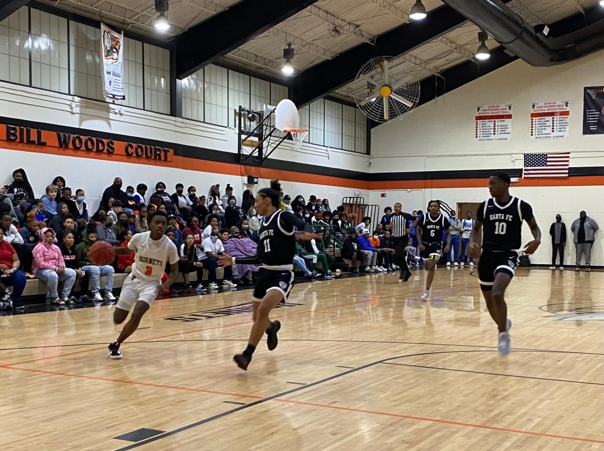 Hawthorne's DJ Slater drives past Santa Fe's Makhi Lewis during the MLK Showcase at Hawthorne Middle/High School on Jan. 17, 2022.