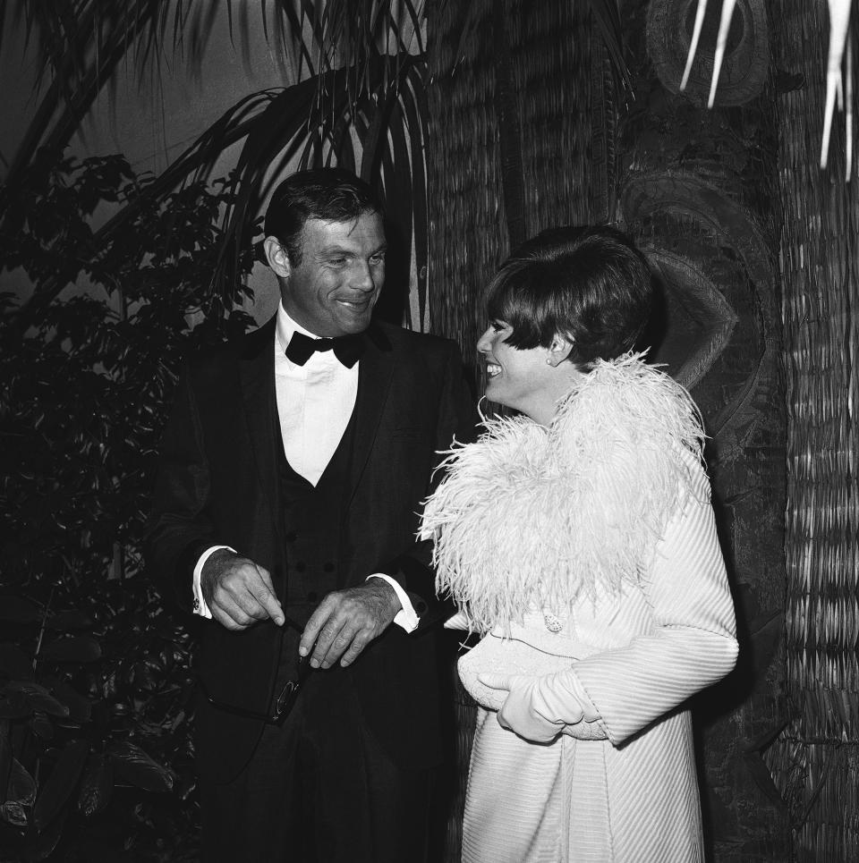 Adam West, and Judy West arrive for a premiere, 1966