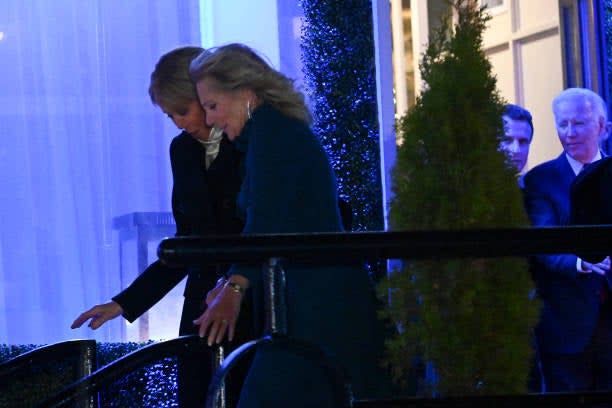 US first lady Jill Biden and French first lady Brigitte  Macron (L) followed by French president Emmanuel Macron and US president Joe Biden leave Fiola Mare restaurant after a private dinner in Washington, DC, on 30 November 2022 (AFP via Getty Images)