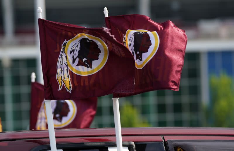 Redskins logos are seen on flags mounted on a vehicle after the team announced they will scrap the name at FedEx Field in Landover, Maryland