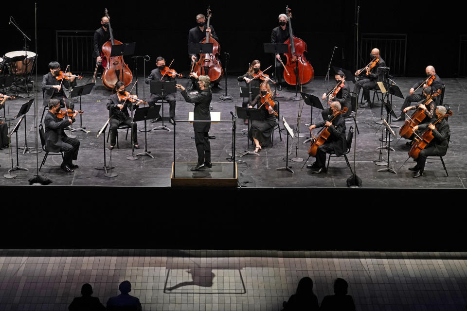 CORRECTS SPELLING OF FIRST NAME TO ESA INSTEAD OF ESSA - Esa-Pekka Salonen, center, music director of the San Francisco Symphony and principal conductor of London's Philharmonia Orchestra, leads the New York Philharmonic before an audience of 150 concertgoers at The Shed in Hudson Yards, Wednesday, April 14, 2021, in New York. It was the first time since March 10, 2020, that the entire orchestra performed together in front of a live audience. (AP Photo/Kathy Willens)