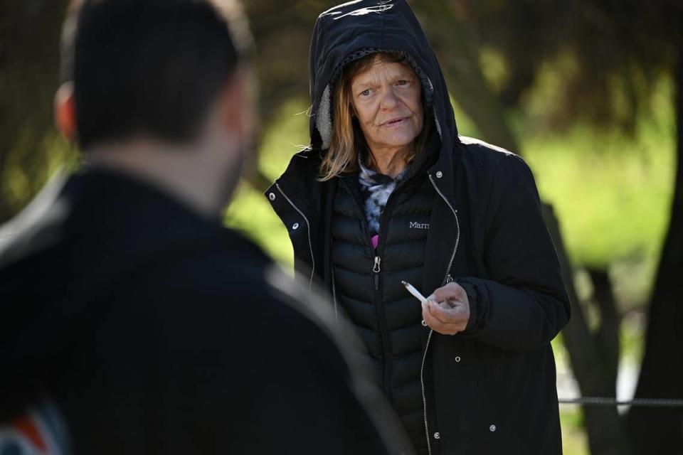 Homeless resident Julie Birkett talks with workers surveying unsheltered people in the Airport district of Modesto, Calif., during Stanislaus County’s Point in Time count of the unsheltered homeless Thursday, Jan. 25, 2024.