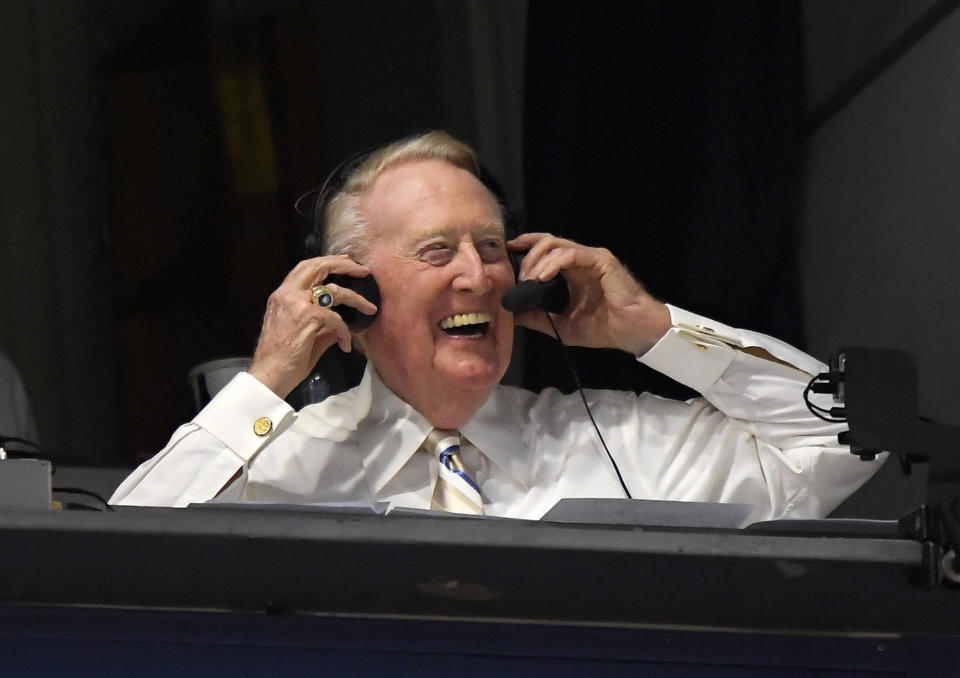 FILE - In this Monday, Sept. 19, 2016, file photo, Los Angeles Dodgers' Hall of Fame announcer Vin Scully puts his headset on prior to a baseball game between the Los Angeles Dodgers and the San Francisco Giants in Los Angeles. Scully, whose dulcet tones provided the soundtrack of summer while entertaining and informing Dodgers fans in Brooklyn and Los Angeles for 67 years, died Tuesday night, Aug. 2, 2022, the team said. He was 94. (AP Photo/Mark J. Terrill, File)