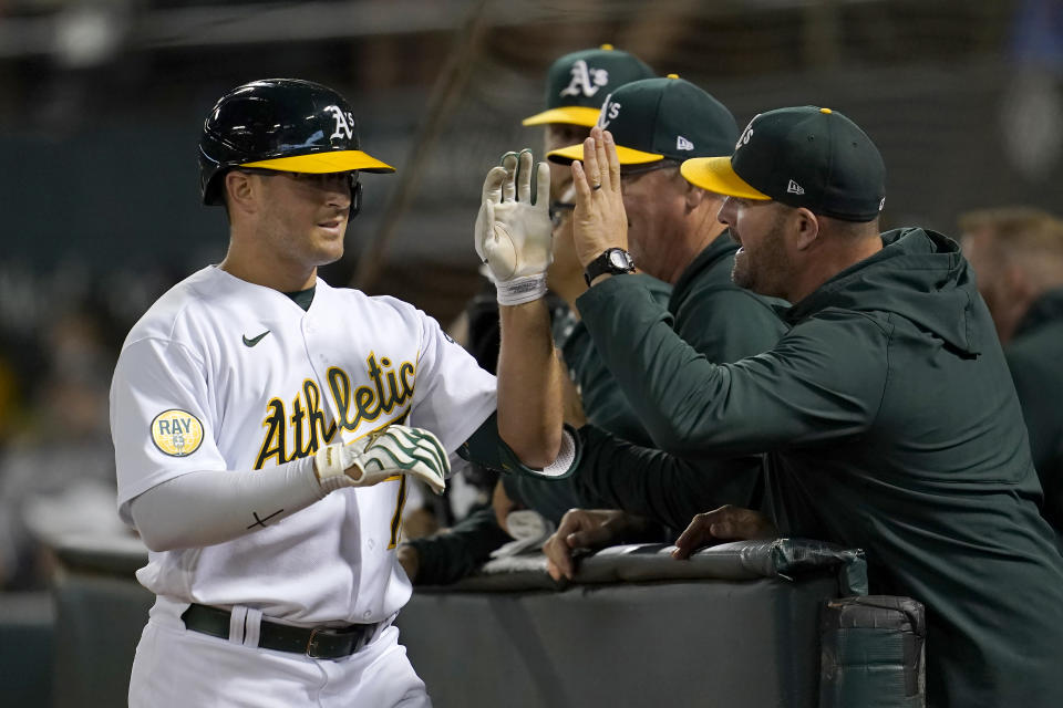 Oakland Athletics' Jonah Bride, left, is congratulated by teammates after hitting a home run against the New York Yankees during the seventh inning of a baseball game in Oakland, Calif., Friday, Aug. 26, 2022. (AP Photo/Jeff Chiu)