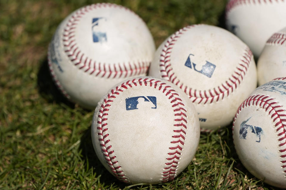 Baseballs are seen on a field during a Philadelphia Phillies baseball spring training workout Thursday, Feb. 22, 2024, in Clearwater, Fla. (AP Photo/Charlie Neibergall)