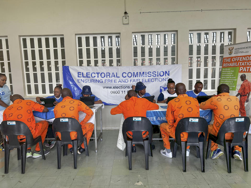 Inmates at the all-male Zonderwater Correctional Centre on the outskirts of Pretoria, South Africa, wait Thursday Feb. 1, 2024, to register as voters or update their details on electoral rolls. The Electoral Commission of South Africa says it hopes to significantly increase the number of prisoners who take part in this year's national election. (AP Photo/Sebabatso Mosamo)