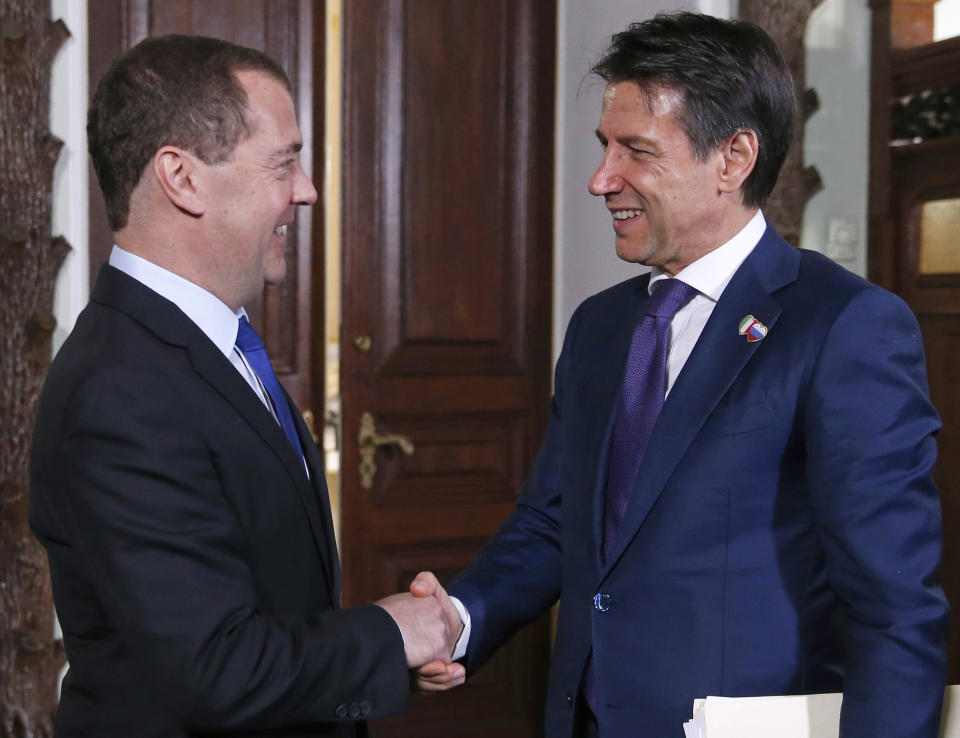 Russian Prime Minister Dmitry Medvedev, left, shakes hands with Italian Premier Giuseppe Conte during a meeting in Moscow, Russia, Wednesday, Oct. 24, 2018. Italian Prime Minister Giuseppe Conte is holding talks with Russian officials on his first trip to Moscow. (Dmitry Astakhov, Sputnik, Kremlin Pool Photo via AP)