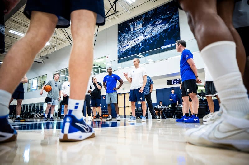 BYU players listen to coach Kevin Young during practice at the Marriott Center Attachment on June 6, 2024, in Provo.  |  Photo by Nate Edwards, BYU