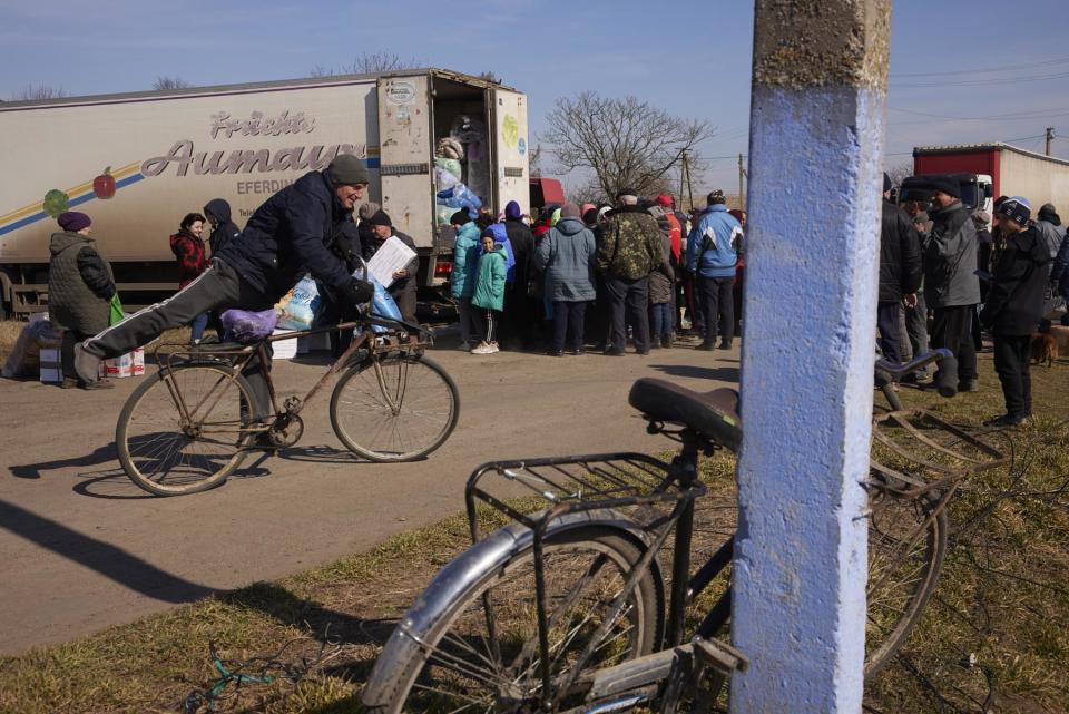 A local resident arrives at an aid delivery from the New Dawn team in Pravdyne, Kherson Oblast, Ukraine on March 8, 2023.