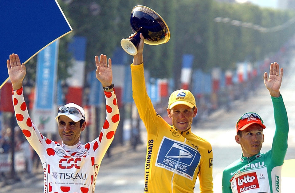 FILE - This July 28, 2002 file photo shows Tour de France winner Lance Armstrong, center, flanked by best sprinter Robbie McEwen, of Australia, right, and best climber Laurent Jalabert, of France, after the 20th and final stage of the Tour de France cycling in Paris. The superstar cyclist, whose stirring victories after his comeback from cancer helped him transcend sports, chose not to pursue arbitration in the drug case brought against him by the U.S. Anti-Doping Agency. That was his last option in his bitter fight with USADA and his decision set the stage for the titles to be stripped and his name to be all but wiped from the record books of the sport he once ruled. (AP Photo/Peter Dejong, File)