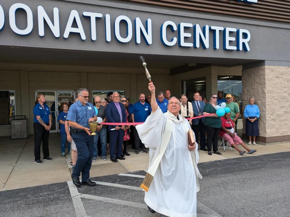 The Rev. Ken York blesses the crowd at the grand opening of The St. Vincent de Paul Thrift Store in Fairview Heights.