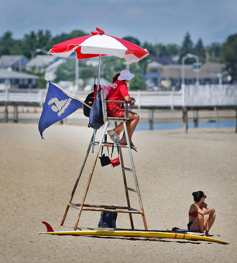 A blue flag on a lifeguard stand at Wollaston Beach indicates that the water is safe for swimming on Wednesday, Aug. 3, 2022.