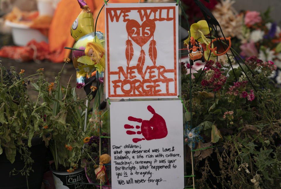 A memorial is seen outside the Residential School in Kamloops, British Columbia., Sunday, June, 13, 2021. The remains of 215 children were discovered buried near the former Kamloops Indian Residential School earlier this month. (Jonathan Hayward/The Canadian Press via AP)