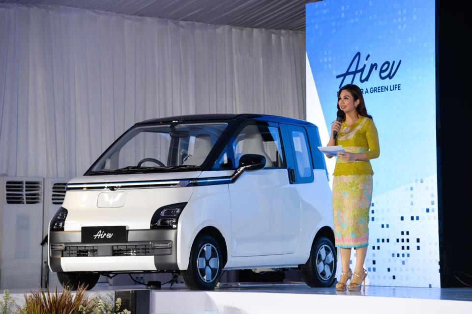 A hostess briefs people on Wuling Air EV during the roll-out ceremony at Wuling's production factory in Bekasi, West Java province, Indonesia, Aug. 8, 2022.  SAIC-GM-Wuling SGMW, a major Chinese automobile manufacturer, through its local unit SGMW Motor Indonesia Wuling, on Monday launched here its production of the electric vehicle in Indonesia, named Wuling Air EV. (Photo by Xu Qin/Xinhua via Getty Images)