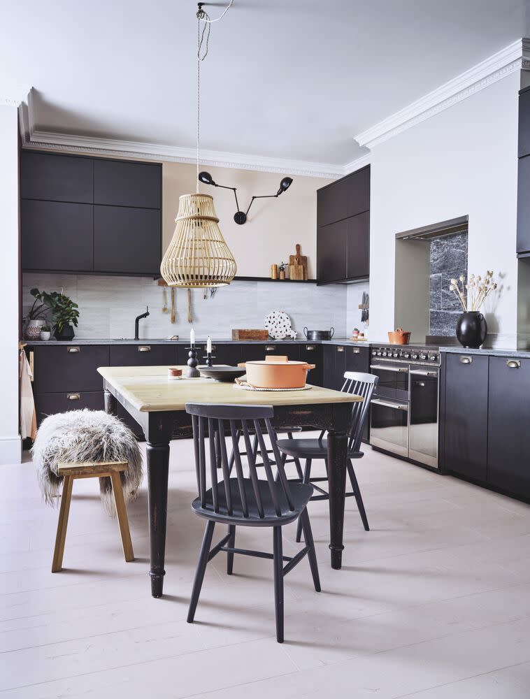 <p>This <a href="https://www.housebeautiful.com/uk/decorate/kitchen/g423/best-kitchen-design-trends/" rel="nofollow noopener" target="_blank" data-ylk="slk:kitchen;elm:context_link;itc:0" class="link ">kitchen</a> uses a clever colour palette technique to brighten an otherwise dark design scheme. Here, the laminate flooring has pinkish undertones that are picked up and reflected in the black cabinets. This technique doesn't require high gloss surfaces to work, just make sure to pick flat panel cabinetry with a subtle sheen.</p><p><strong>Pictured: <a href="https://www.carpetright.co.uk/laminate/sensation-candy-cane-4754-painted-oak-rose-laminate/" rel="nofollow noopener" target="_blank" data-ylk="slk:House Beautiful Sensation Candy Cane Painted Laminate at Carpetright;elm:context_link;itc:0" class="link ">House Beautiful Sensation Candy Cane Painted Laminate at Carpetright</a></strong></p>