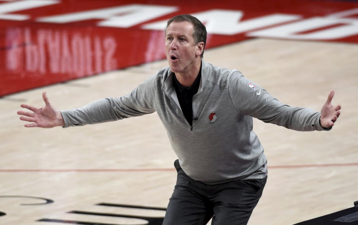 Terry Stotts throws his arms to the side as he reacts to an official's call.