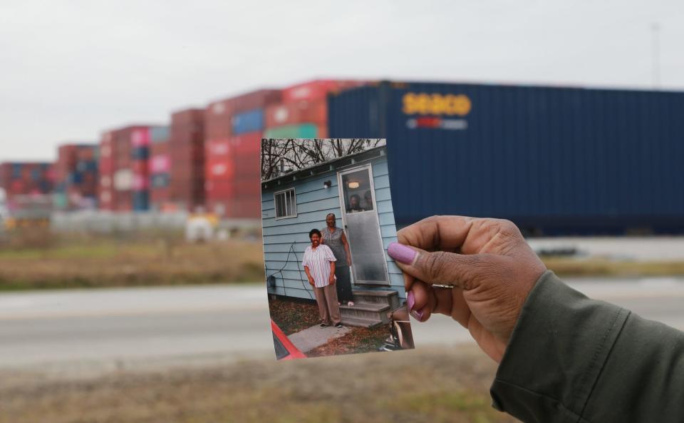 Pamela Deloach holds up a photo showing her aunt's Ray Street home which once stood in an area now covered by containers at the Georgia Ports Authority.
