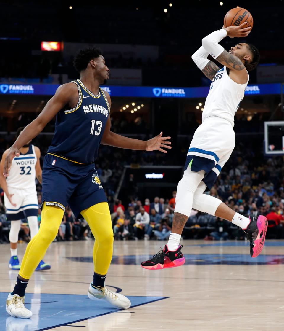 Apr 26, 2022; Memphis, Tennessee, USA; Memphis Grizzlies forward Jaren Jackson Jr. (13) guards Minnesota Timberwolves guard D'Angelo Russell (0) as he shoots a three-point field goal during the second half of game five of the first round for the 2022 NBA playoffs at FedExForum. Mandatory Credit: Christine Tannous-USA TODAY Sports