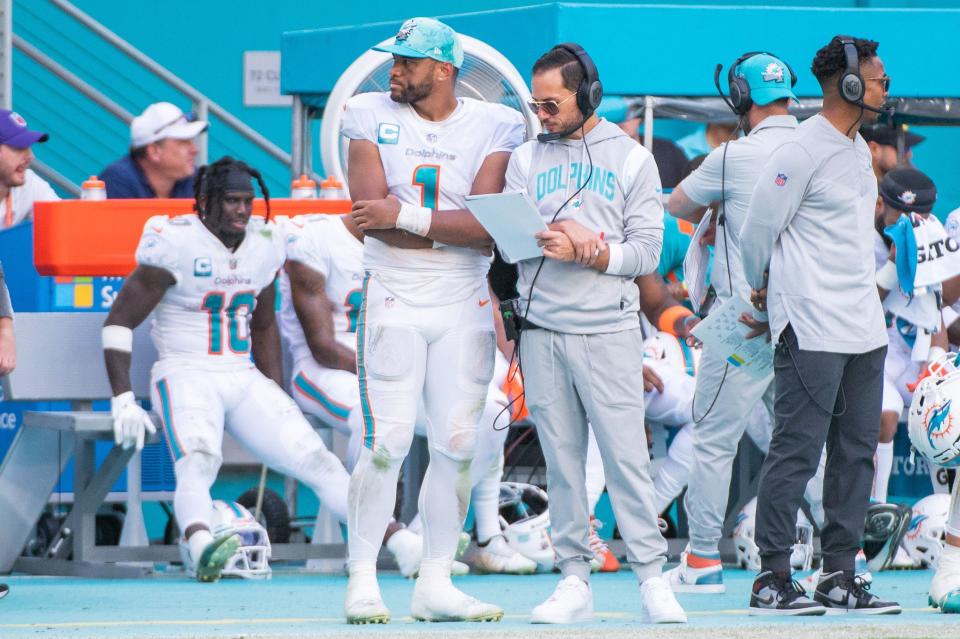 Miami Dolphins quarterback Tua Tagovailoa stands with head coach Mike McDaniel at the Miami bench on Nov. 22 in the second half of the game between the Dolphins and the Houston Texans at Hard Rock Stadium in Miami Gardens. The Dolphins won 30-15.