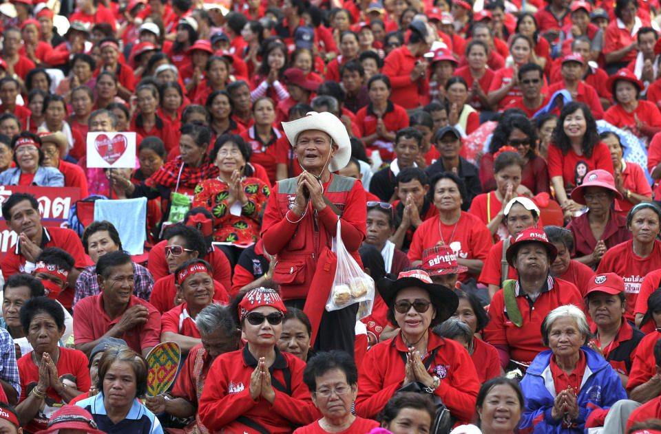 FILE - In this May 19, 2012, file photo, protesters attend a prayer session during a rally at Ratchaprasong Intersection in Bangkok, Thailand. Thailand's Yellow Shirts and Red Shirts represent two opposing political factions: respectively, opponents of former Prime Minister Thaksin Shinawatra, and his supporters. The Red Shirts rose in response after Thaksin was ousted in a September 2006 military coup. (AP Photo/Sakchai Lalit, File)