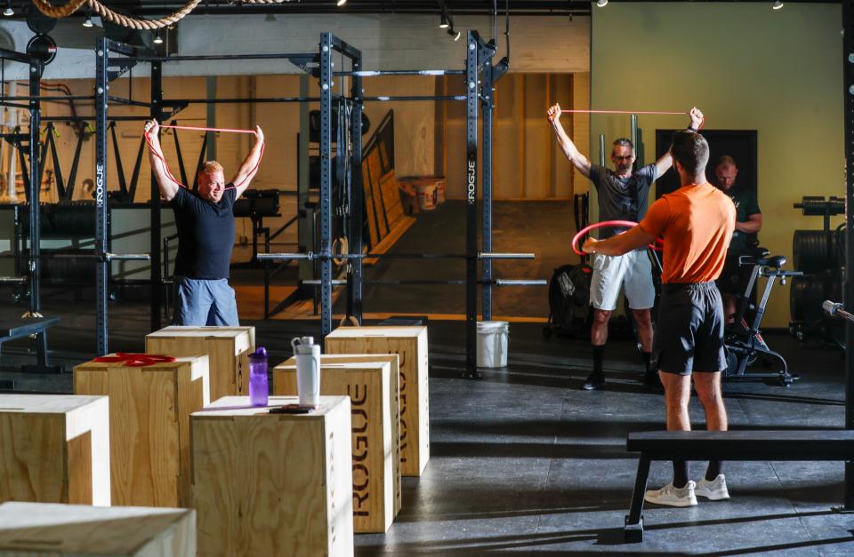 A group does stretching exercises before a training session at Full Tilt Gym, 2008 Eastern Parkway near Bardstown Road.