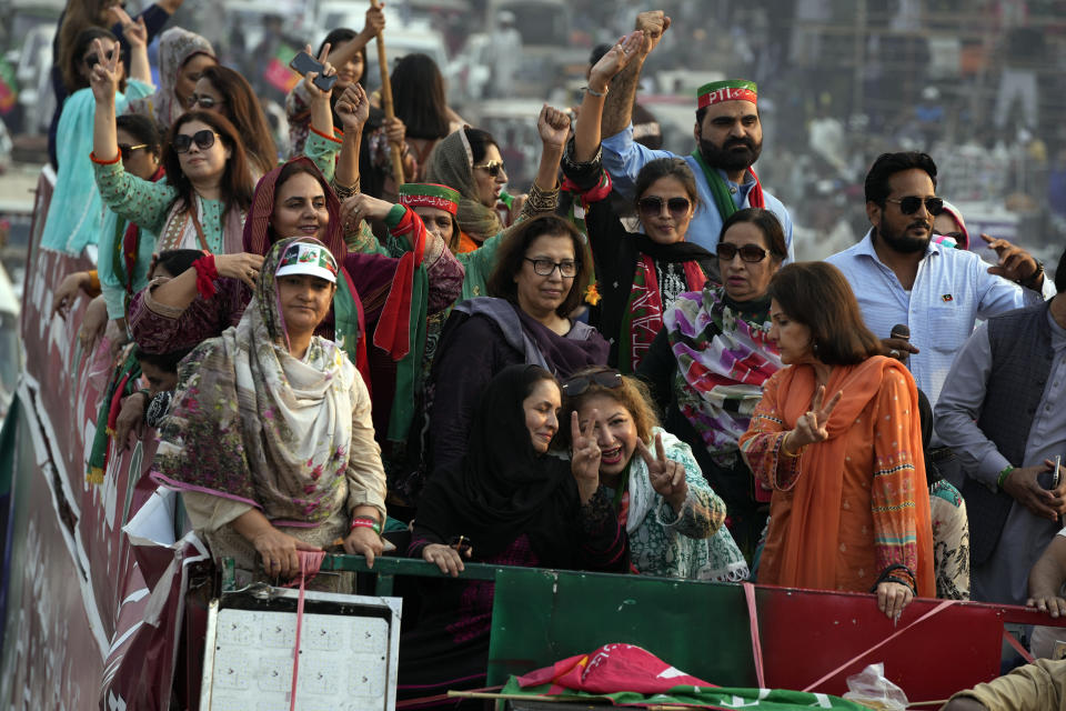 Supporters of Pakistan's main opposition 'Tehreek-e-Insaf party' listen the speech of their leader Imran Khan at a rally in Lahore, Pakistan, Saturday, Oct. 29 2022. Khan along with thousands of his supporters in a large convoy of buses and cars Friday began his much-awaited march on the capital Islamabad from the eastern city of Lahore to demand the holding of snap elections, a sign of deepening political turmoil. (AP Photo/K.M. Chaudary)