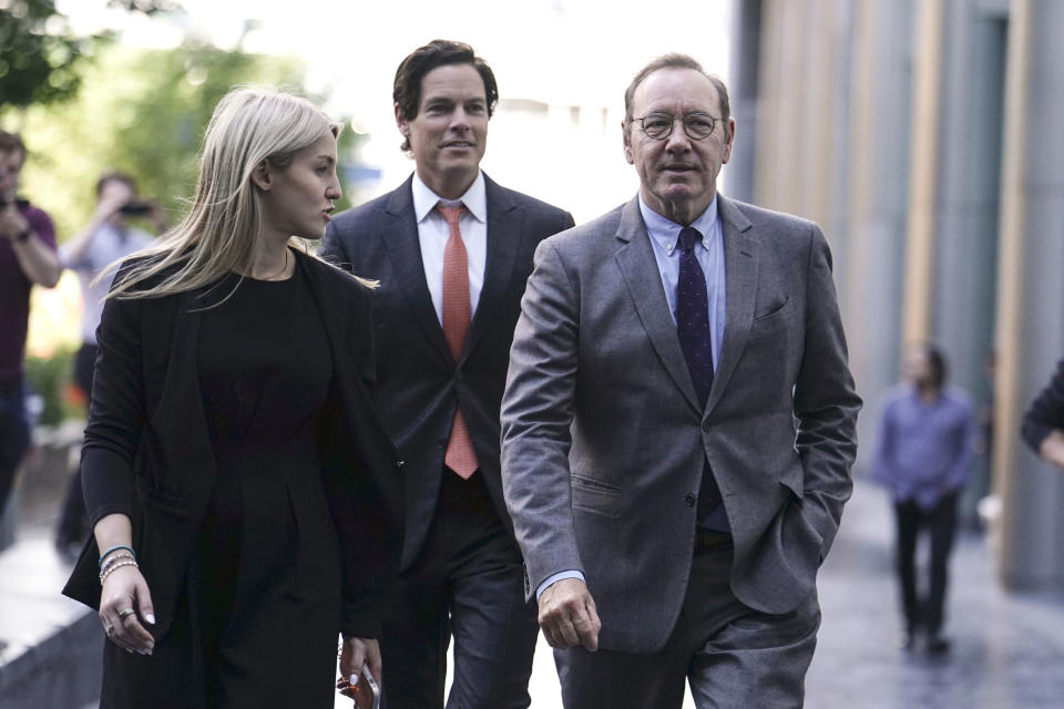 Actor Kevin Spacey, right, walks outside Southwark Crown Court, London, Monday July 17, 2023. Elton John briefly testified Monday for the defense at Kevin Spacey's sexual assault trial as the actor's lawyer attempted to discredit a man who claimed the Oscar winner aggressively grabbed his crotch while driving to the singer's summer ball. (Jordan Pettitt/PA via AP)