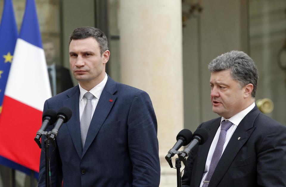 Vitali Klitschko, former heavyweight boxing champion and Ukrainian leader of UDAR party, left, and former Ukrainian foreign minister Petro Porochenko talk to reporters after a meeting with French president Francois Hollande, at the Elysee Palace, in Paris, Friday, March 7, 2014. The Ukrainian politicians discussed the current situation in Ukraine with the French President. (AP Photo/Christophe Ena)