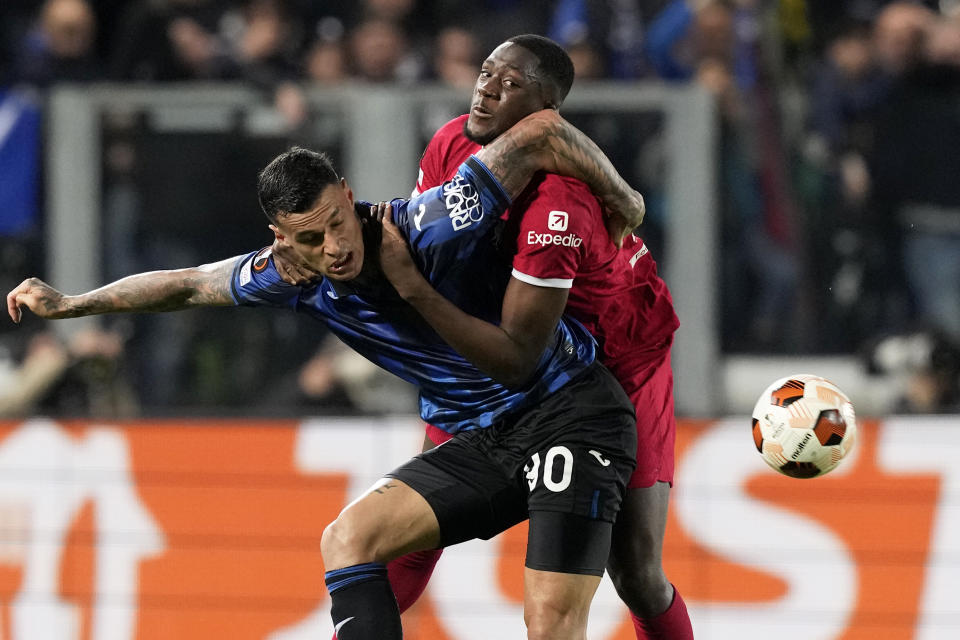 Liverpool's Ibrahima Konate fights for the ball with Atalanta's Gianluca Scamacca, left, during the Europa League quarterfinal, second leg, soccer match between Atalanta and Liverpool at the Stadio di Bergamo, in Bergamo, Italy, Thursday, April 18, 2024. (AP Photo/Antonio Calanni)