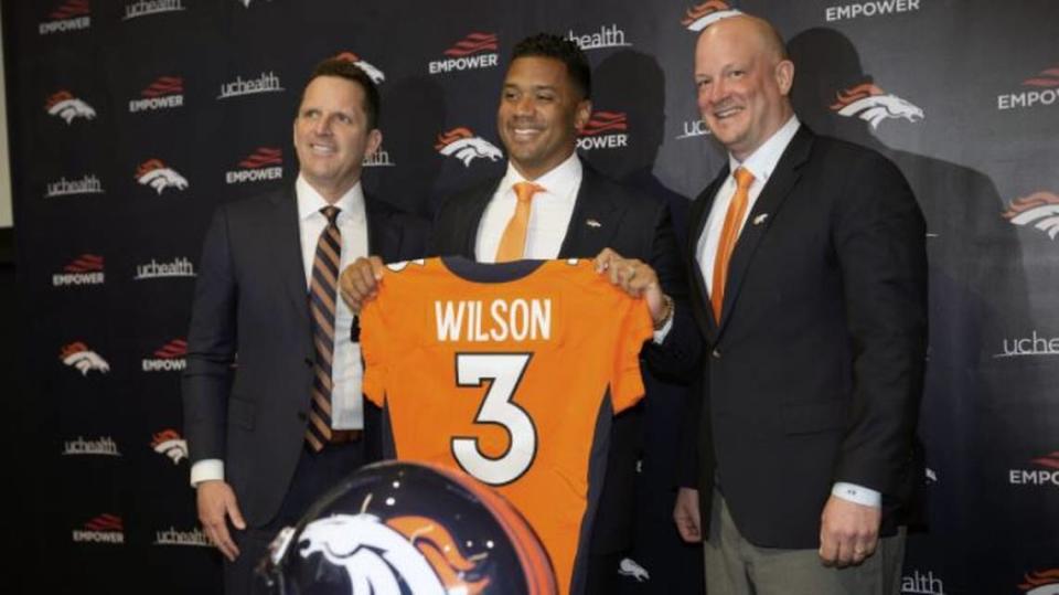 Now-former Seahawks quarterback Russell Wilson, center, is flanked by Denver head coach Nathaniel Hackett, right, and Broncos general manager George Paton after his introductory news conference Wednesday, March 16, 2022, at the team’s headquarters in Englewood, Colorado.