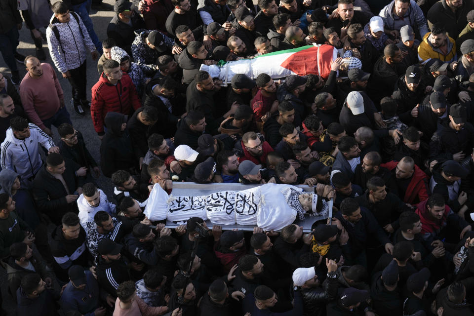 Palestinians carry the bodies of men killed in clashes with Israel troops in the West Bank city of Nablus , Wednesday, Feb. 22, 2023. Palestinian officials say that at least 10 Palestinians have been killed and 102 were wounded during a rare daytime Israeli army arrest raid in the occupied West Bank. The Palestinian Health Ministry says a 72-year-old man was among the dead. (AP Photo/Majdi Mohammed)