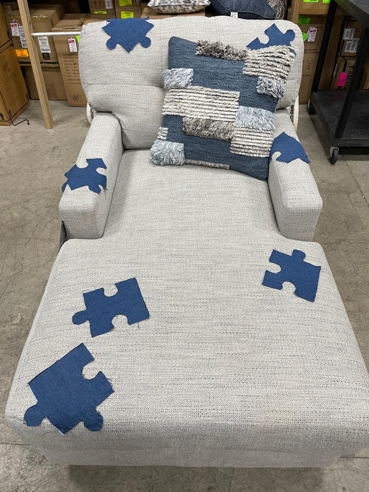 Chaise lounge with handsewn puzzle piece patches donated by Coconis Furniture for the Eastside Community Ministry CHAIR-ity auction.