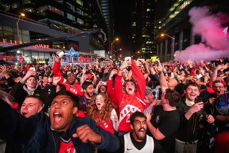 Fans react at Jurassic Park as the Toronto Raptors advance to the NBA finals after defeating the Milwaukee Bucks in game six of the NBA Eastern Conference finals in Toronto, Ontario, Canada, May 25, 2019. REUTERS/Carlos Osorio