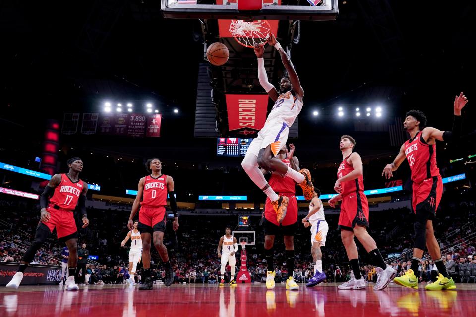 Phoenix Suns' Deandre Ayton (22) dunks the ball against the Houston Rockets during the first half of an NBA basketball game Wednesday, March 16, 2022, in Houston.