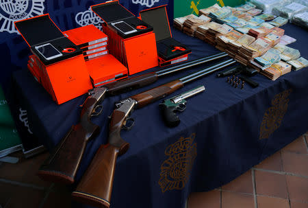 Police display arms and other material which was seized during a drug bust in which officials have seized more than six tonnes of cocaine hidden among bunches of bananas at an industrial estate at the police headquarters in Malaga, Spain, October 25, 2018. REUTERS/Jon Nazca