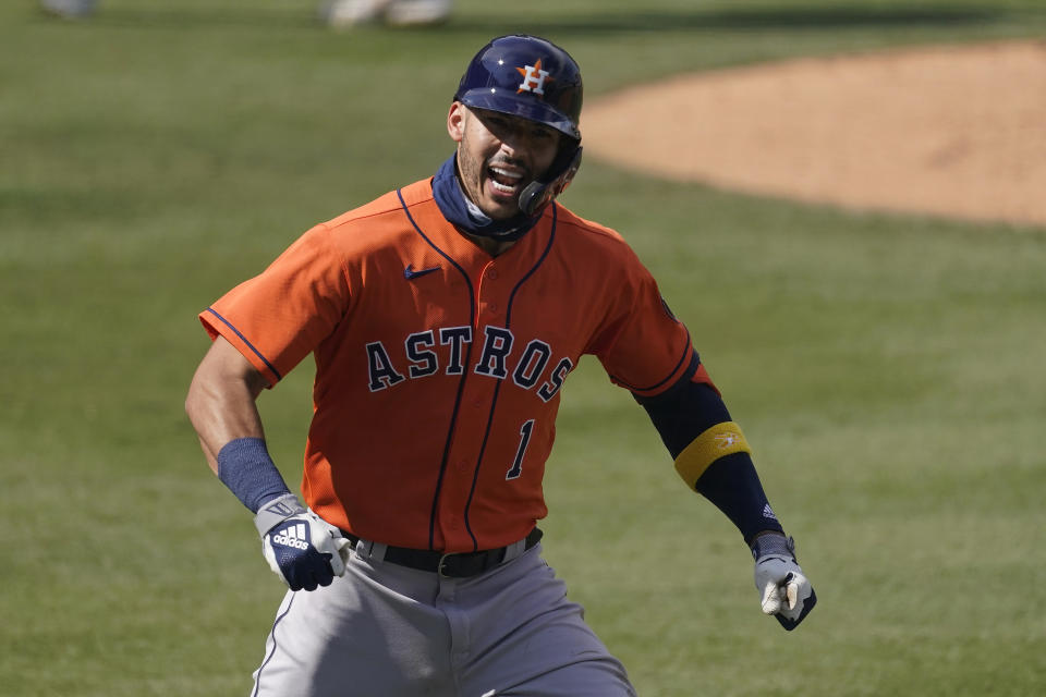 Houston Astros' Carlos Correa celebrates after hitting a two-run home run against the Oakland Athletics during the fourth inning of Game 1 of a baseball American League Division Series in Los Angeles, Monday, Oct. 5, 2020. (AP Photo/Ashley Landis)