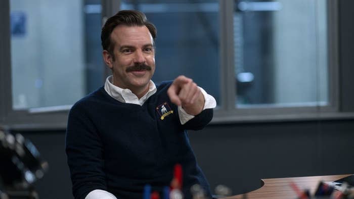 Jason Sudeikis smiling and pointing in Ted Lasso