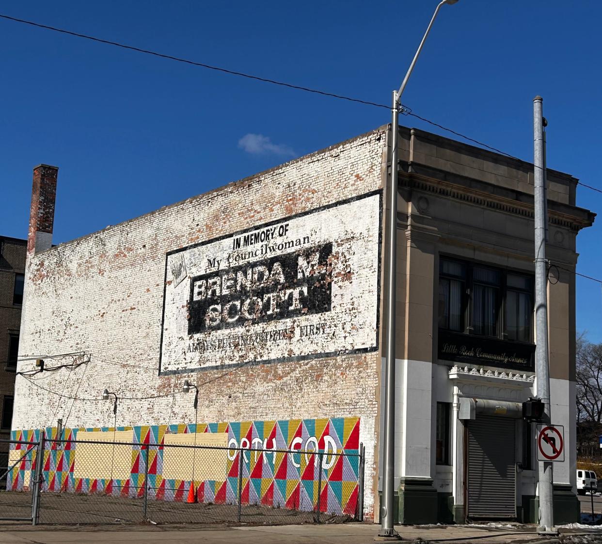 A faded white sign in Detroit's North End memorializes former City Council member Brenda M. Scott who died in 2002.